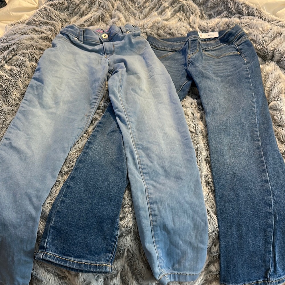 2 pair girls jeans light colored has a small spot